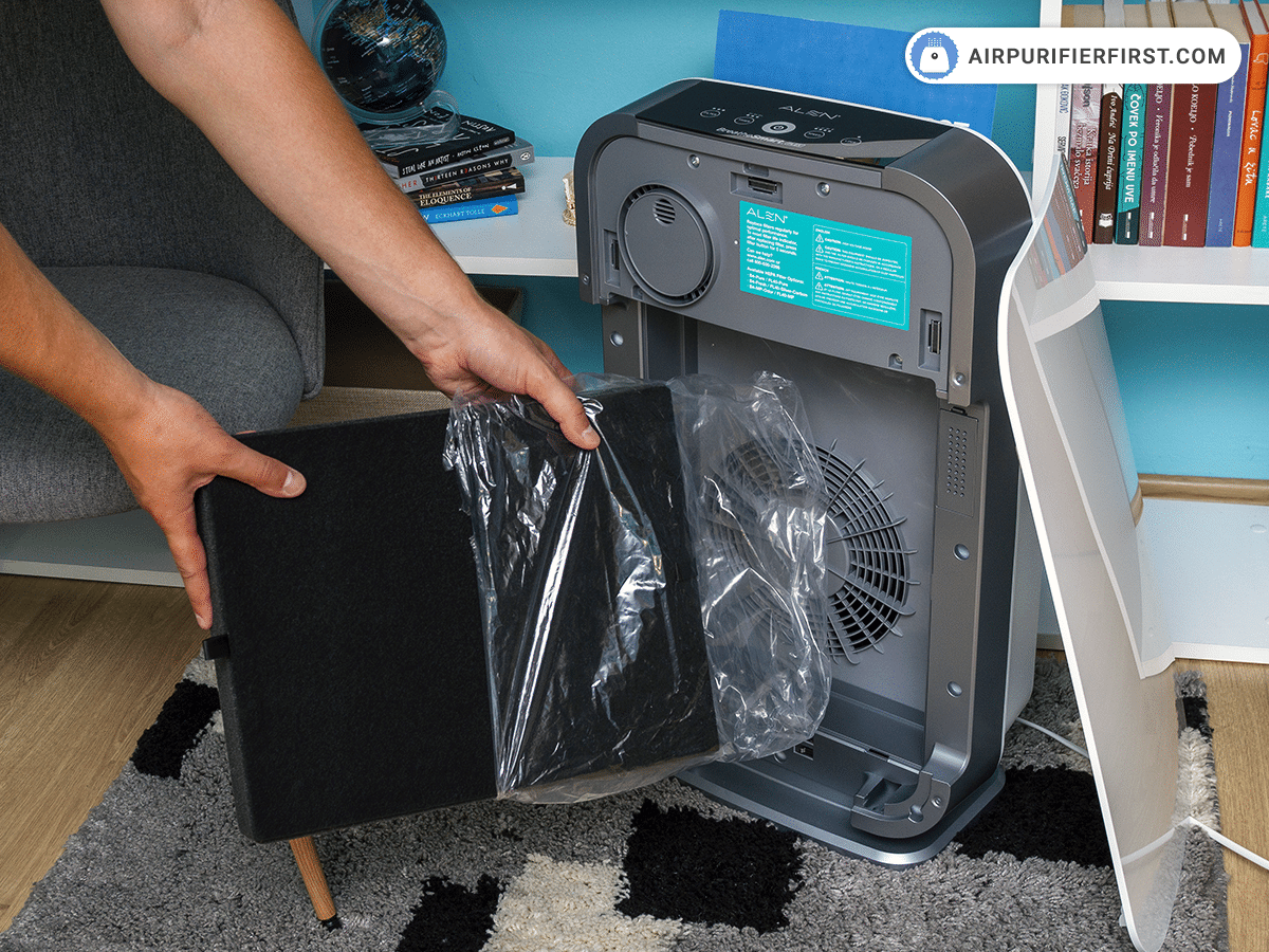 Removing plastic bag from a new filter.