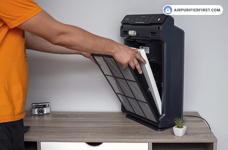 Remove the pre-filter by pressing the tabs near the top, and after that, pull out the old AOC Carbon and True HEPA filters.